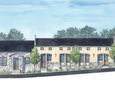 Watercolor rendering of a row of buildings with stone and stucco facades, dark roofs, and trees.