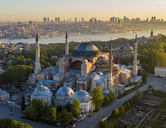 Hagia Sophia with Istanbul skyline and Bosphorus strait in background at sunrise