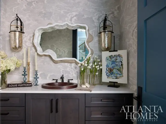 Powder room with cloud wallpaper, copper sink, and abstract art