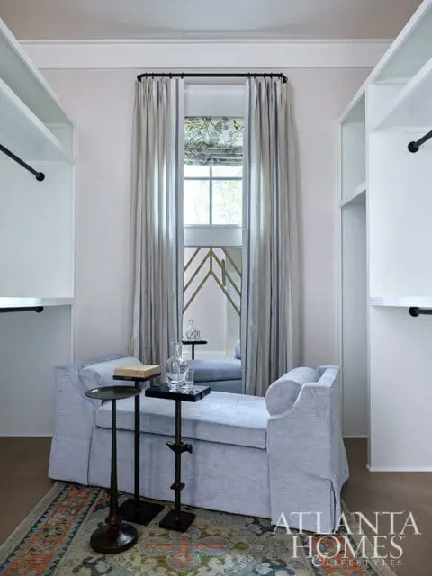 Light blue chaise lounge with side tables and striped curtains. Atlanta Homes & Lifestyles logo.