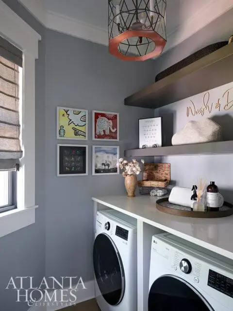 Laundry room with gray walls, white LG washer and dryer, and decorative art.