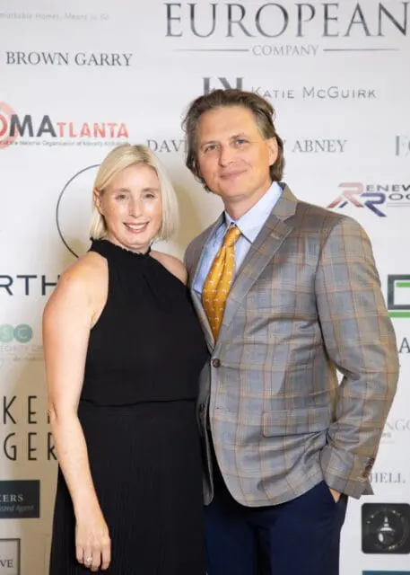 Woman in black dress and man in plaid suit with yellow tie