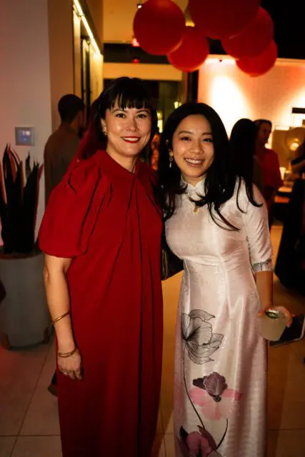 Jessica Davis in red dress and Michelle Ngo in white floral dress