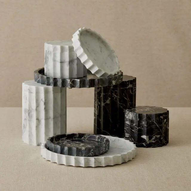 Fluted marble boxes and trays in white and black with gold veining