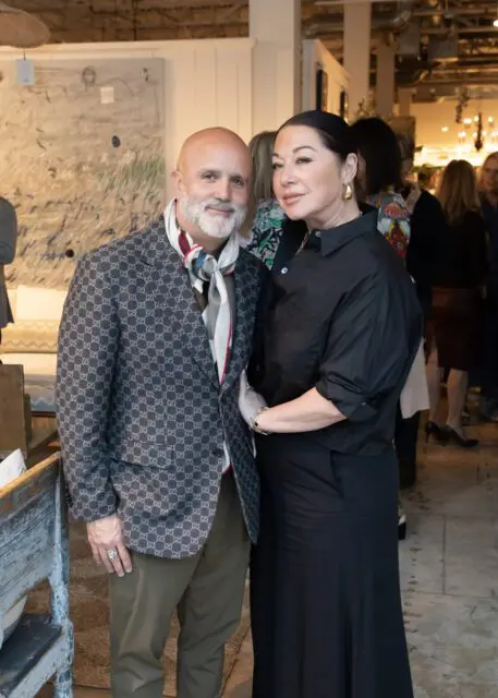 Man in patterned jacket and woman in black shirt and skirt