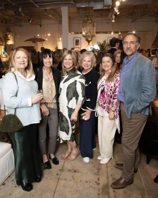 Six people posing for a photo indoors.