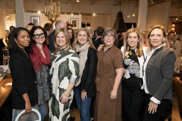 Group of six women posing for a photo indoors.