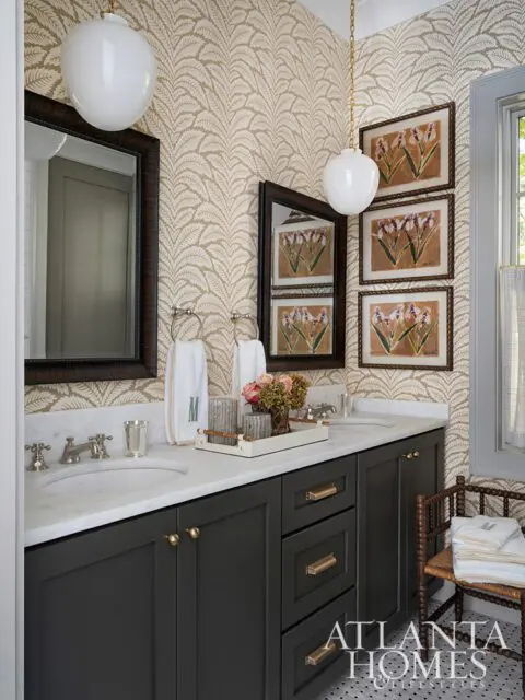 Dark gray vanity with marble countertop, botanical wallpaper, and framed floral art.