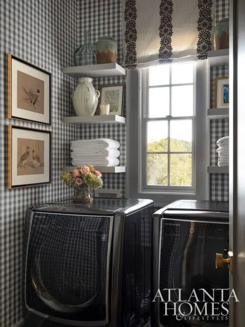 Laundry room with black LG Signature washer and dryer, gingham wallpaper, and framed bird art.