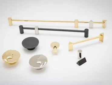 Various metal cabinet hardware including pulls and knobs in brass, black, and brushed nickel