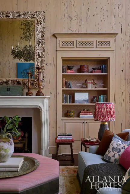 Living room with fireplace, built-in bookshelf, and upholstered furniture.