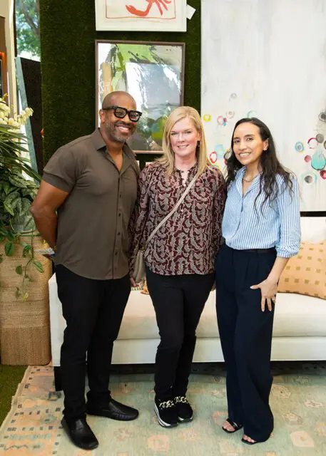 Man in brown shirt, woman in patterned shirt, and woman in blue striped shirt