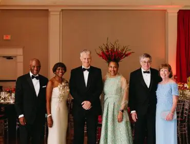 Six people in formal attire posing for a photo.