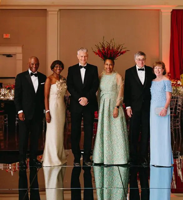 Six people in formal attire posing for a photo.