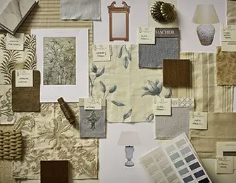 Mood board with fabric swatches, a small mirror, lamp, and artwork samples.