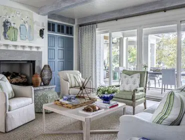 Living room with fireplace, light gray sofa, green armchair, and light wood coffee table.