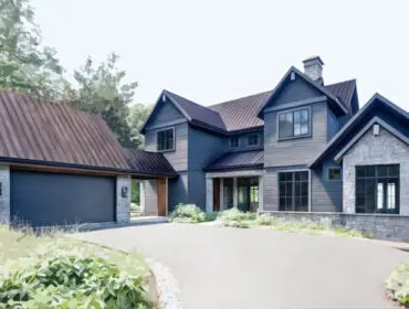 Modern home with dark blue siding, stone accents, and a metal roof. Attached garage with a dark