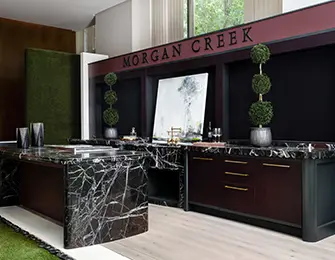 Dark marble desk and cabinetry with 'MORGAN CREEK' text above