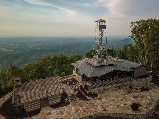 Fire tower and lodge on a mountaintop with a scenic overlook