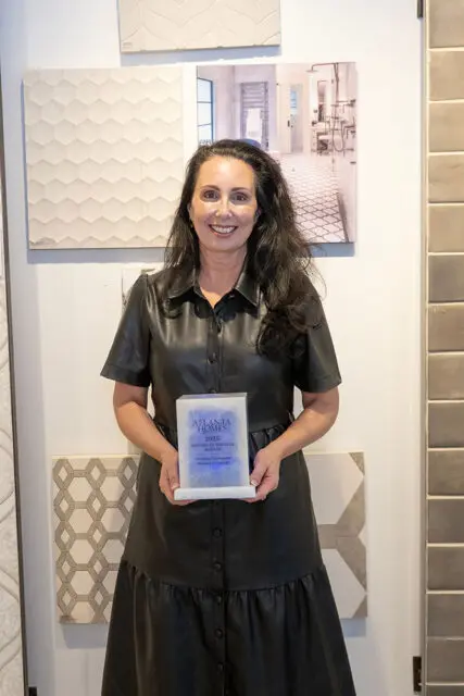 Woman in black dress holding Atlanta Homes 2025 Kitchen of the Year award