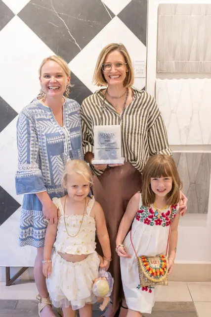 Two women and two young girls holding an award that reads 'Atlanta Homes 2025 Bath of the Year
