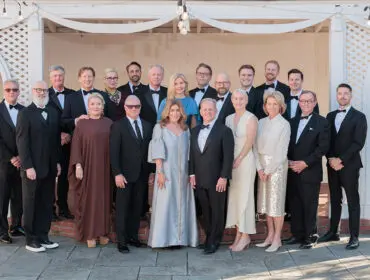 Group of people in formal attire posing for a photo.