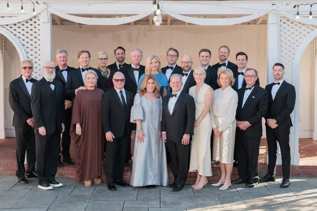 Group of people in formal attire posing for a photo.