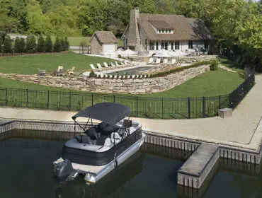 Luxury home with pool and boat dock on a lake