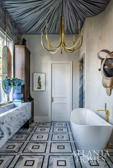 Bathroom with marble vanity, freestanding tub, patterned floor, and draped ceiling