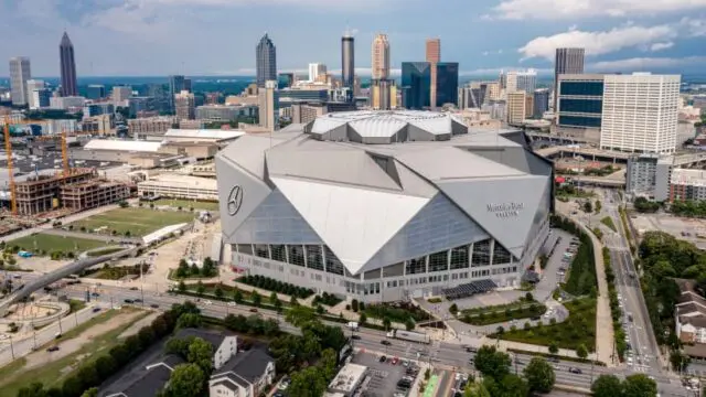 Mercedes-Benz Stadium with Atlanta skyline in background