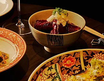 Bowl of food with shredded daikon radish and green onions