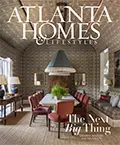 Atlanta Homes & Lifestyles magazine cover. Interior kitchen scene with dining table and text: 'The