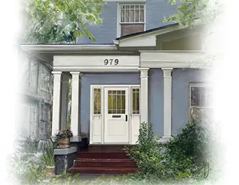 Blue Victorian house with white front door and columns.
