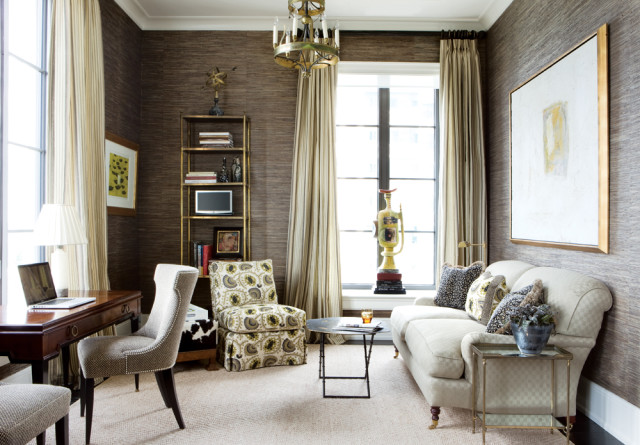 Office with dark textured wallpaper, a wooden desk with a laptop, a patterned armchair, a cream sofa, and a large abstract painting on the wall.