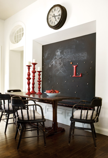 Dining room with dark wood table and chairs, red candelabras, and a chalkboard wall with a baseball player drawing and 'GO BRAVES!' text.