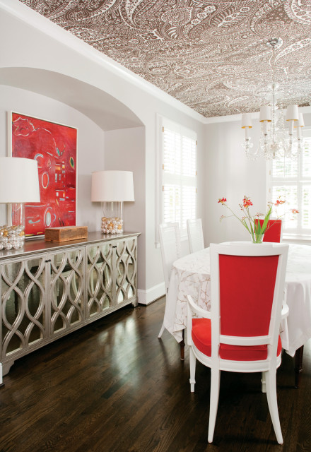 In the dining room—and throughout the house—a neutral palette prevails, interspersed with pops of red. Reclaimed oak flooring replaced ceramic tile in this space; stained to match the home’s existing hardwood floors, it allows for a seamless transition from room to room.
