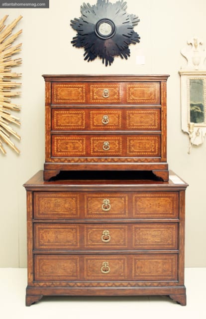 Two antique wooden chests of drawers with intricate marquetry inlay and brass hardware, displayed against a neutral wall with decorative mirrors.