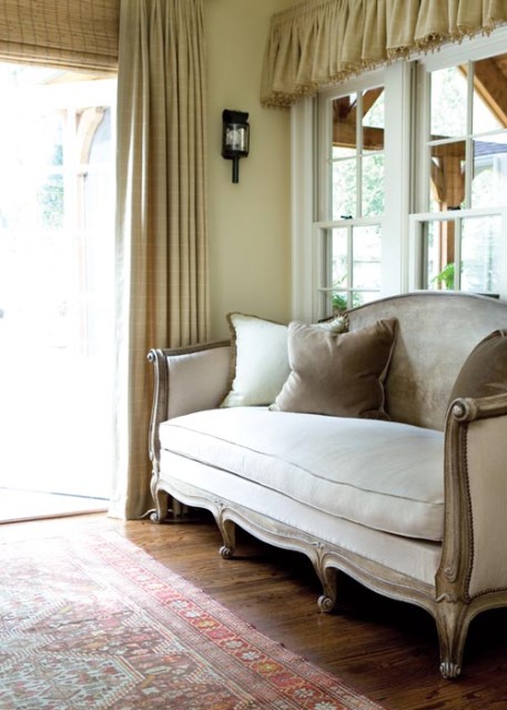 This French daybed was originally painted lemon yellow and white, and was missing its back. Angela had it repaired and refinished. It was one of just two pieces she kept from the previous house.