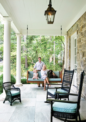 The Ansleys take a break on the porch of their new Charles Heydt- and Gwyn Duggan-designed home. Lanterns, Bevolo.