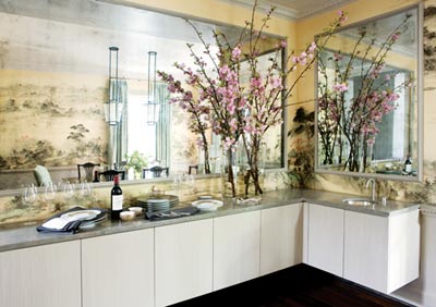Steinfeld and the architects designed a sleek buffet with a sink, which can double as a convenient ice bucket or chiller for wine and Champagne. Above the buffet, the frame-like moldings existed, but she replaced their cream-colored interiors with antiqued mirror panels.
