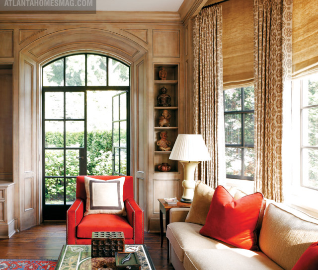The library is one of the most utilized rooms in the house; here, children and dogs alike are welcome on the Holly Hunt Collection chairs and Lee Jofa wool twill-covered sofa. The walls were custom painted to look like limed oak, and the paneling is faux-painted. Curtain fabric, Pintera Studios. Roman shade fabric, Sabina Fay Braxton.