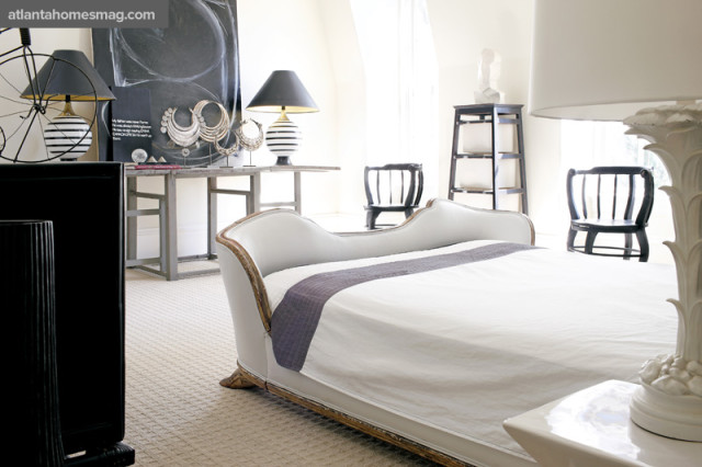 Opposite a 19th-century white leather French bed, an artistic arrangement hints at Williams’ self-professed “thing for circles.” A black-and-white work by Craig Schumaker is propped atop a Swedish drop-leaf table, flanked by a pair of vintage lamps and fronted by Chinese white bronze tribal necklaces. Bed, Mimi Williams Interiors.