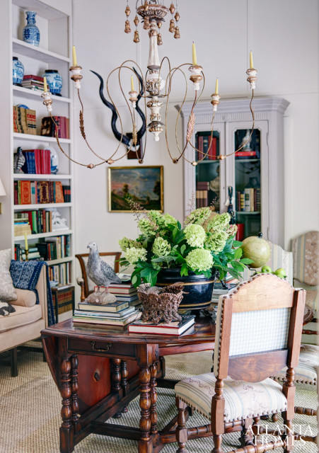"In the classical manner, Charles gave the room much symmetry," says Kathleen Rivers of the interior design legend known for his fondess for French Country. "However, as one who was confident of his style, he did what many great artists do in their paintings: throw in the unexpected. The giant arrangement of hydrangeas off-center of the table, the etagere with elan horns and painting on one side and a simple chair on the other, all reflect his choice to 'paint' the room in three-dimensional fashion. Whatever it took to create the harmony he was seeking."