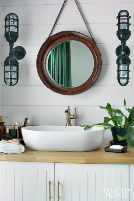 A mix of high and low price points allows you to feel indulgent- without breaking the bank. Sconces from barnlightelectric.com. Leather mirror from Go Home at AmericasMart. Vanity cabinet and countertop from IKEA. Vessel sink from Delta. Vanity hardware from Colonial Bronze Co. through Masterpiece Lighting.