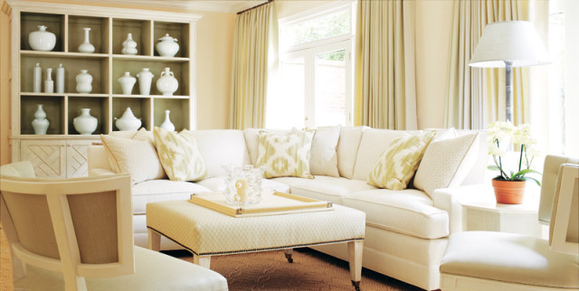 Playing off the walled garden just beyond the French doors, Howard brought the outside in on the terrace level, peppering the space with soft greens. Here, too, she designed a custom cabinet with fretwork detailing along the back wall. “I wanted to showcase Karen’s Blanc de Chine collection while adding some storage. I chose to paint the inside green to really make the white pop,” she explains.