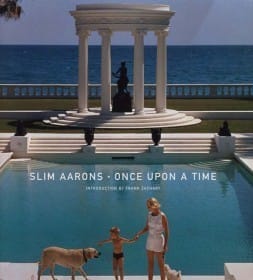 Slim Aarons: Once Upon a Time book cover featuring a woman and child with dogs by a pool, with a classical pavilion in the background.