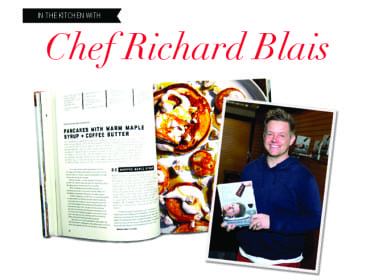 Chef Richard Blais holding his cookbook "Try This At Home" next to an open cookbook with a recipe for pancakes.