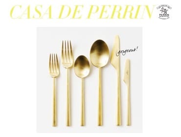 Set of six brushed gold flatware pieces including forks, spoons, and knives, with the word "gorgeous!" written in script on one knife.