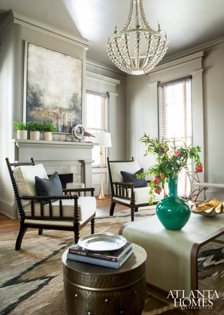 One of the home’s two main living rooms is a study in soft khaki featuring an eye-catching ikat rug and richly finished bobbin chairs that positively pop against the neutral backdrop.