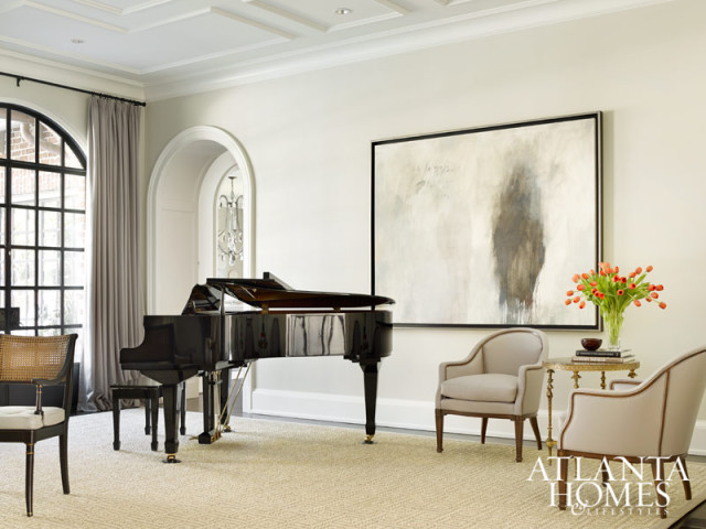 Grand steel-and-glass doors, a Dessin Fournir chandelier and a geometric ceiling motif add intrigue in the formal living room. Drapery, Rogers & Goffigon. Mantel, François & Co.